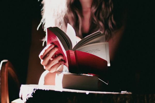 A calm and focused person sitting in a well-lit room, embodying concentration.
